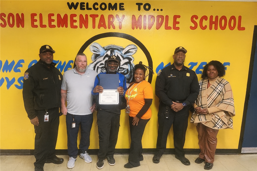  safety officer standing with certificate with other staff